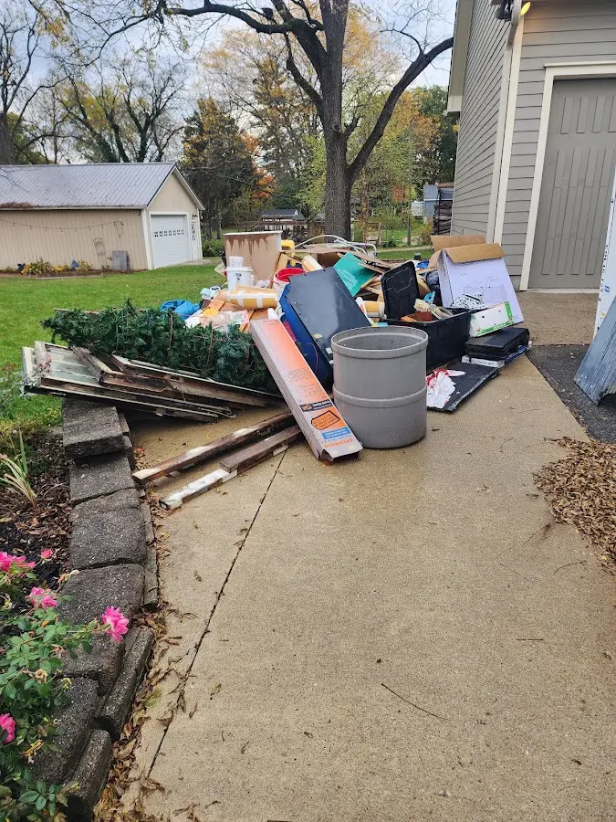 Dumpster being loaded with debris for 12 Yard Dumpster Rental in Central Gardens